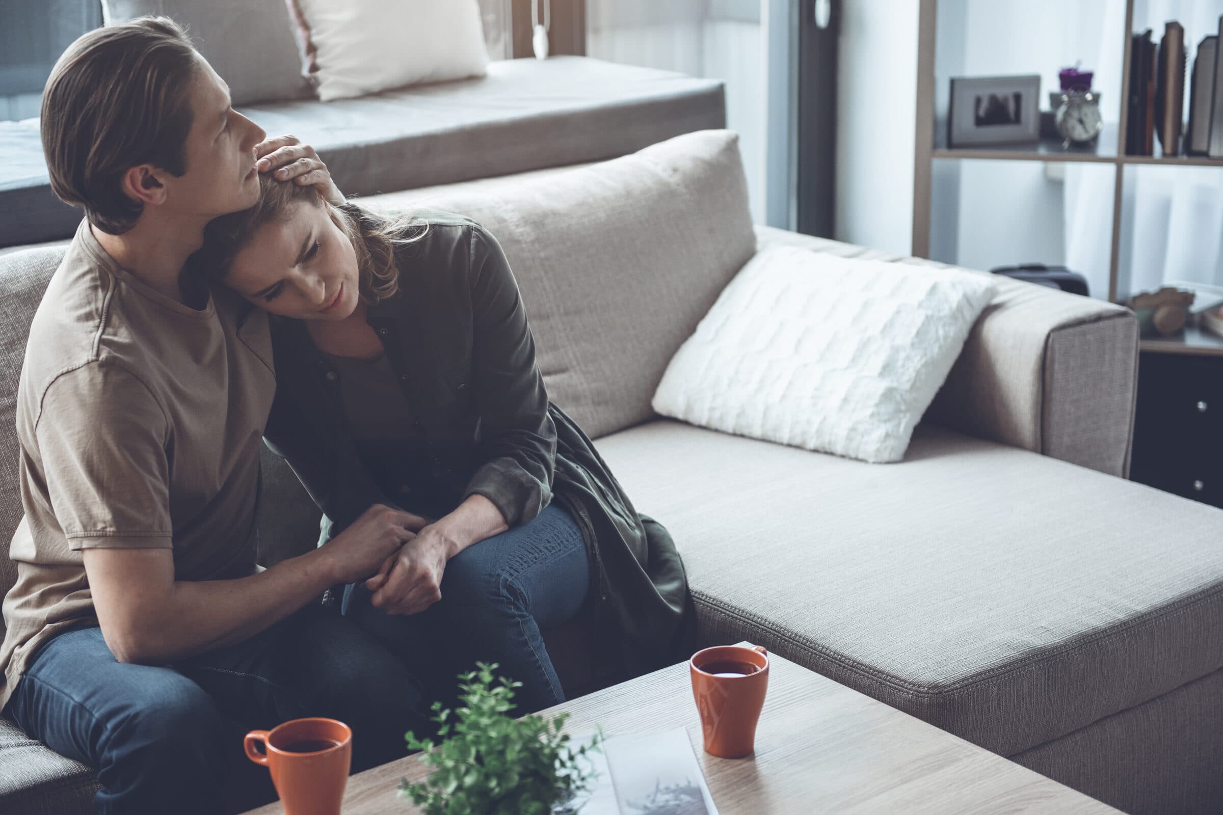 A worried couple reviewing past-due medical bills after a serious injury